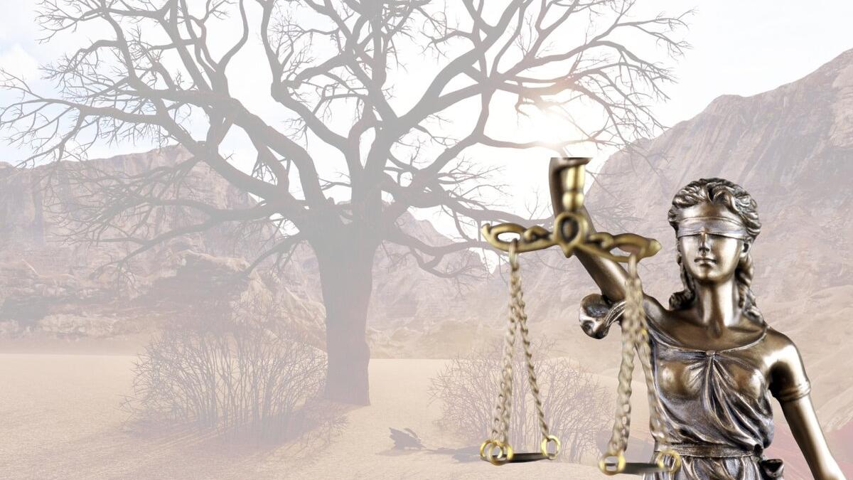 The symbol of Justice with an image of the desert in the background