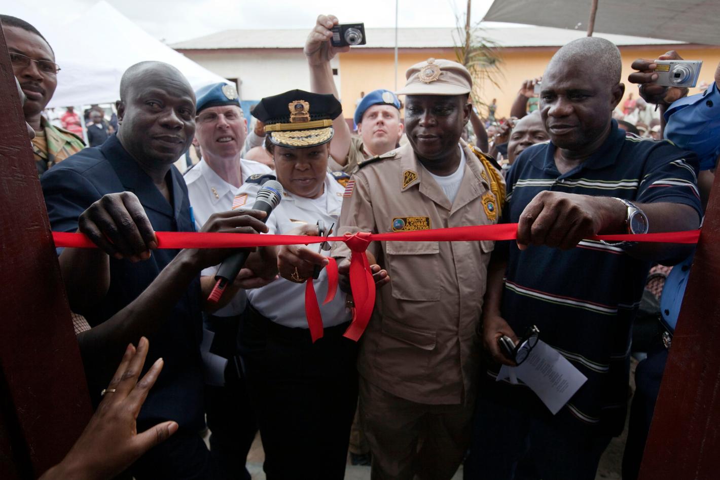 Police officers cut a red ribbon to open the new security depot.