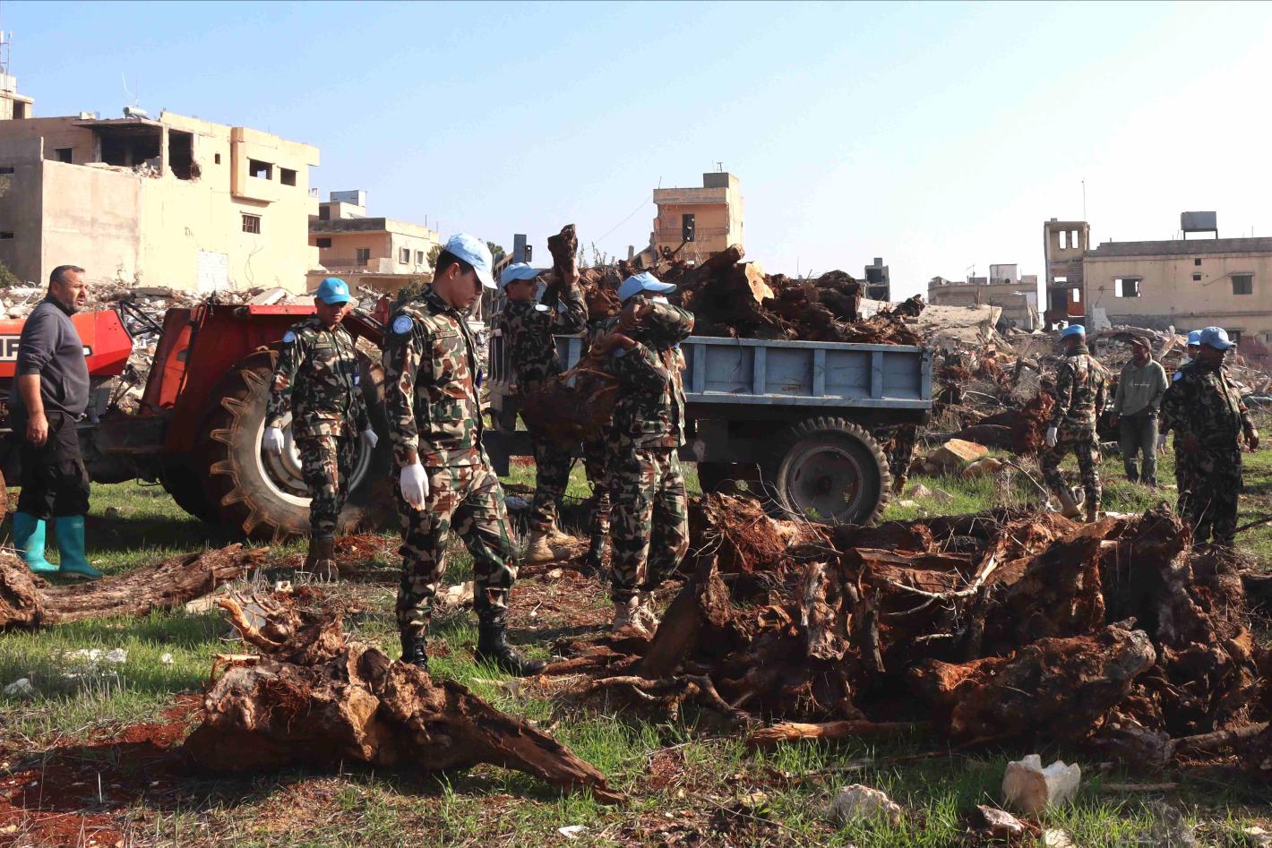 Peacekeepers assist Blida residents to prepare field for olive plantation